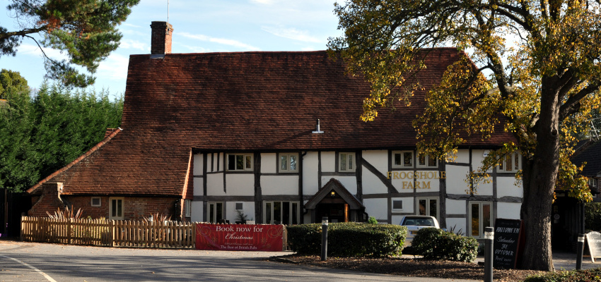 old house with sign: Frogshole Farm