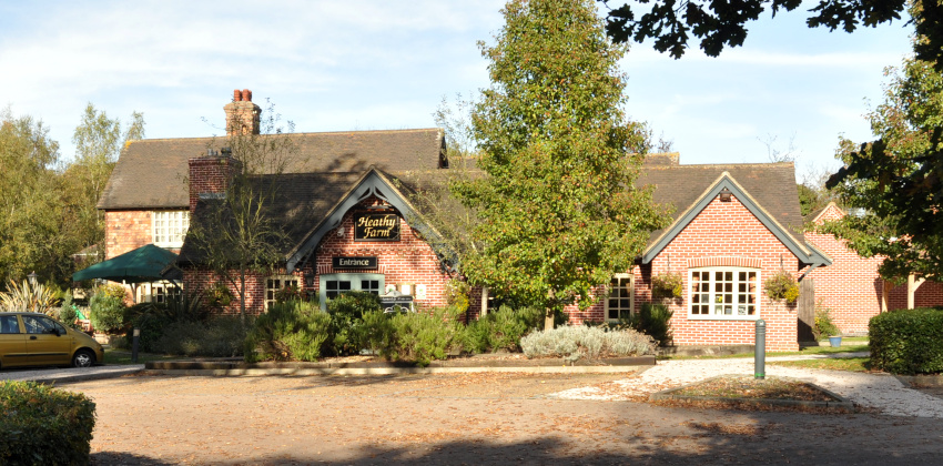 brick building with parking area in front