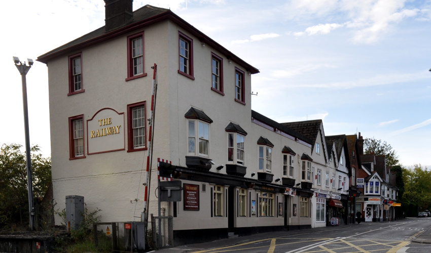 pale building next to a level crossing